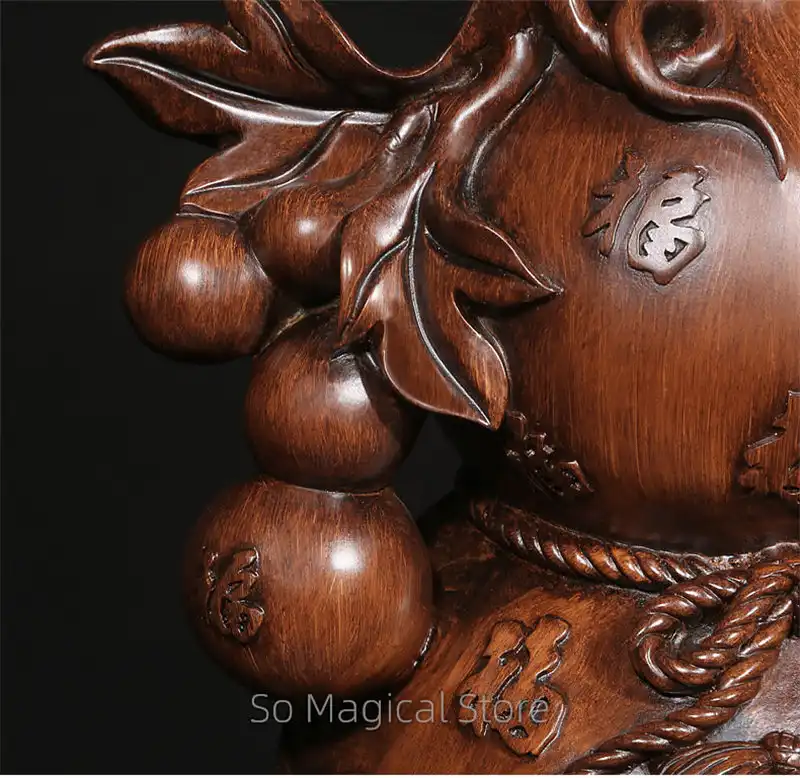 Golden wu lou gourd in traditional Chinese home setting with cultural decor elements.
