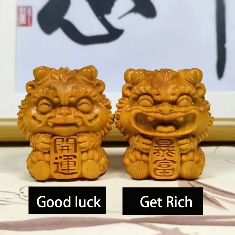 Wooden foo dog statues placed on office desk demonstrating compact 5cm size for workspace decoration.