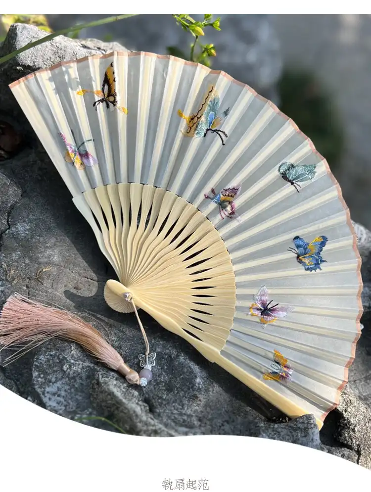 Artisan craftsmanship detail showing bamboo and silk construction quality of decorative fan.
