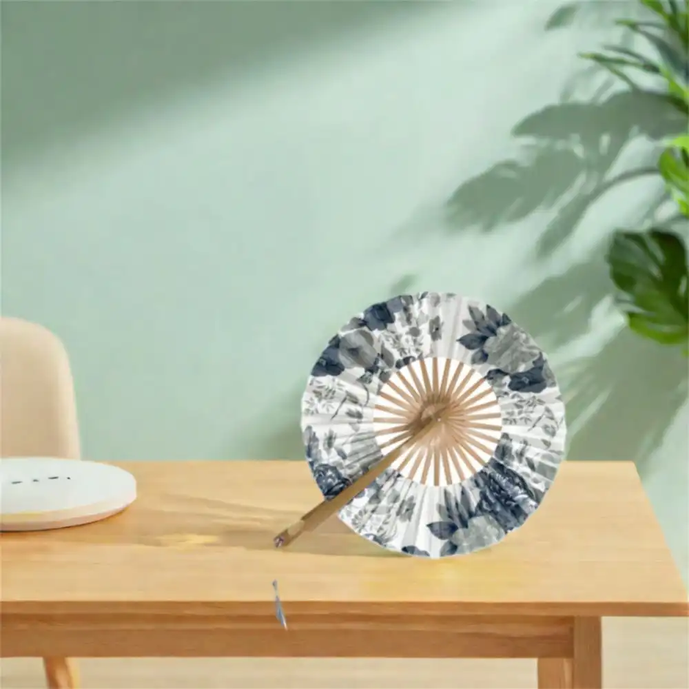 Classical circular bamboo fan fully opened displaying elegant windmill pattern and traditional Oriental aesthetics.