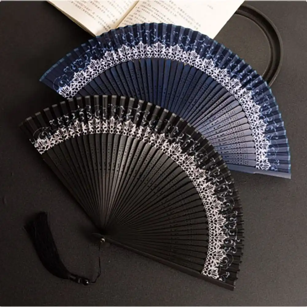 Japanese bamboo silk fan in folded position displaying compact portable design for travel.