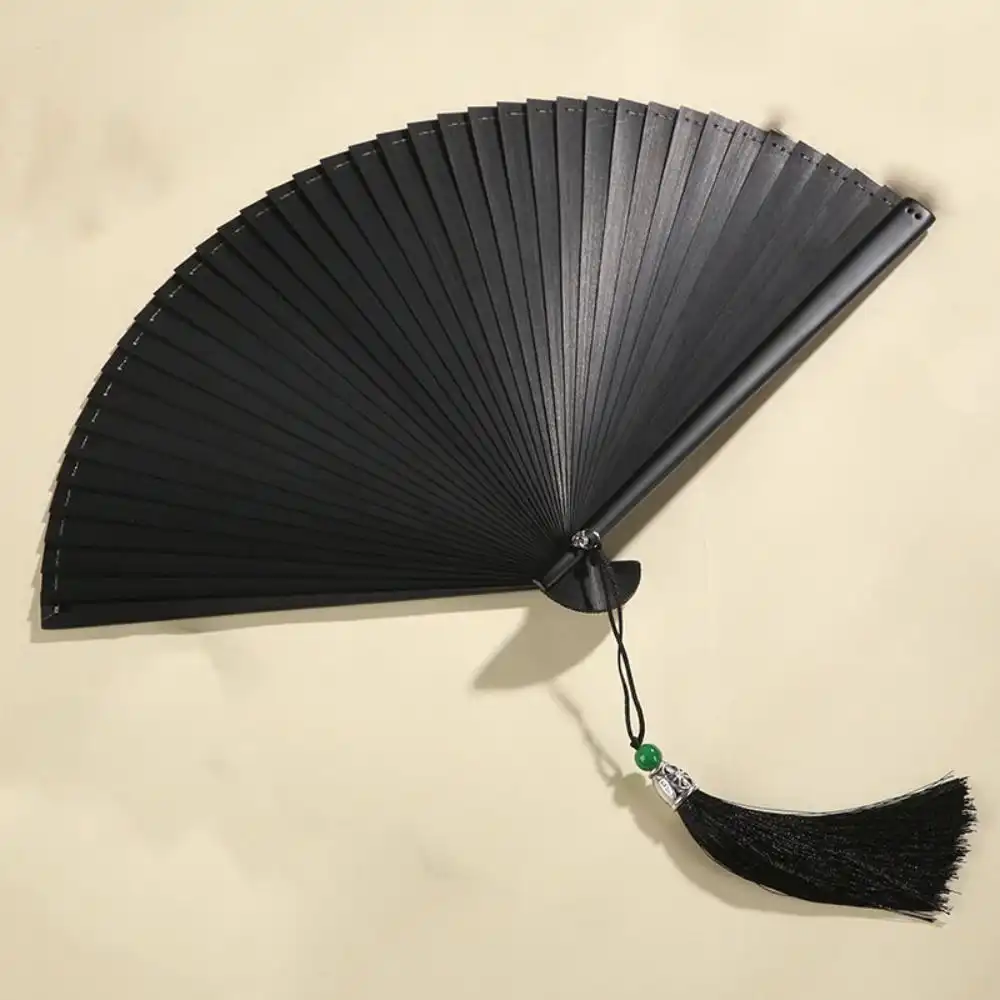 Closed compact folding dance fan showing 16cm portable size and bamboo construction quality.