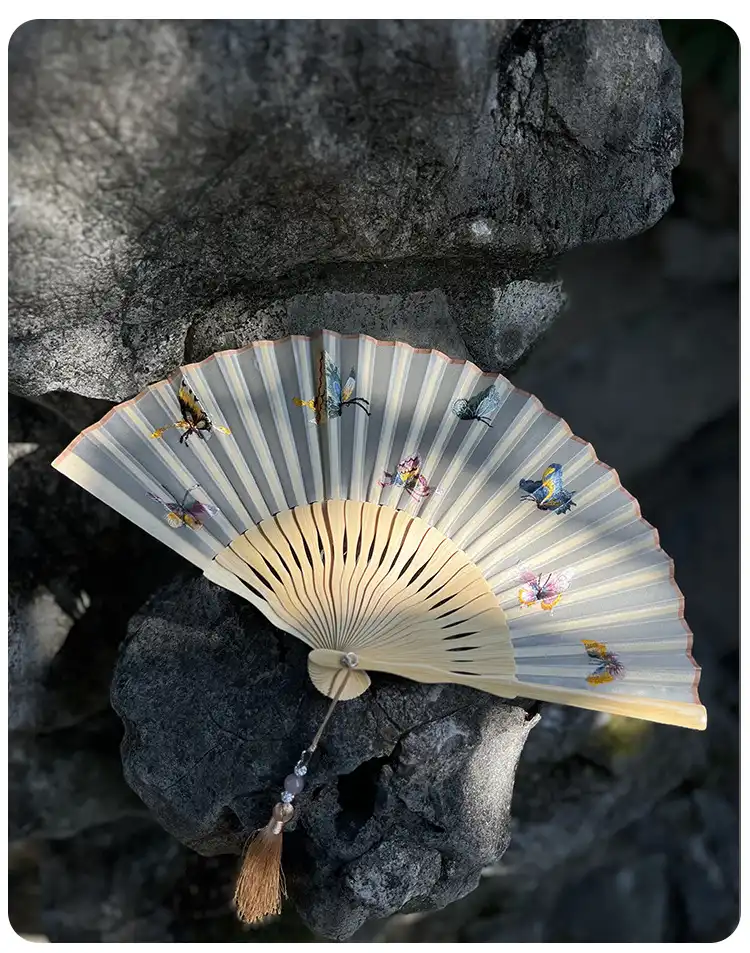 Multiple angles of embroidered bamboo fan showcasing detailed needlework and color variations.