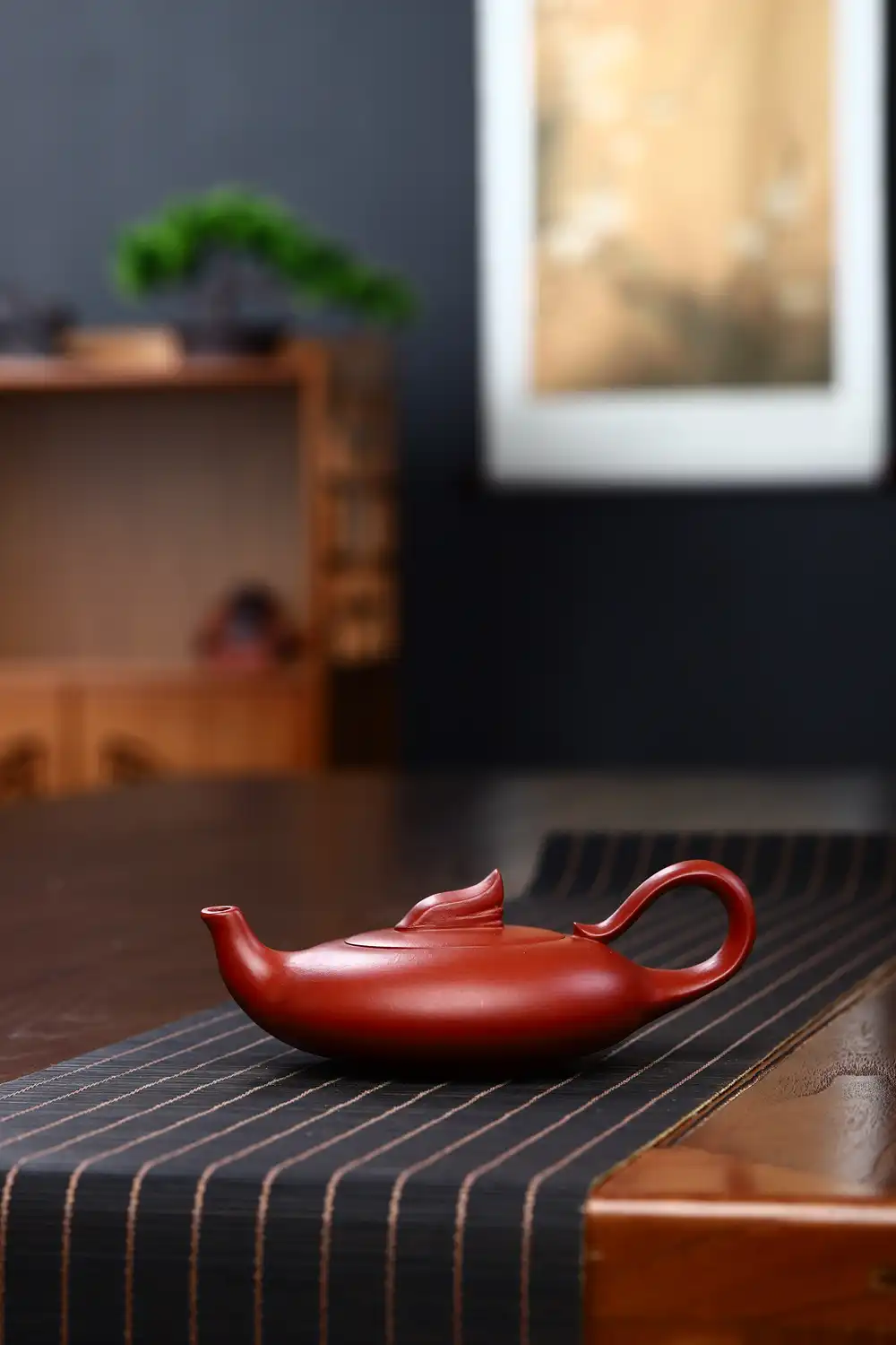 Folk artist crafting authentic Yixing teapot using traditional pottery techniques and raw ore clay.