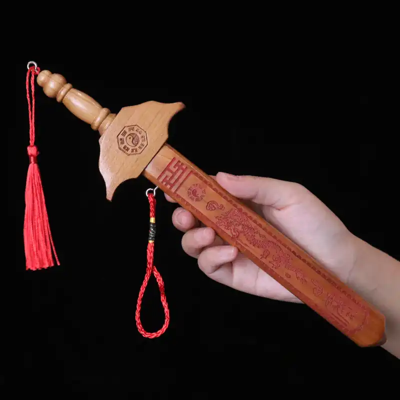 Peach wood sword handle detail displaying natural mahogany wood texture and secure grip design.