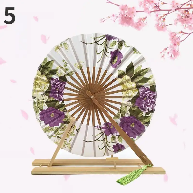 Detailed shot of decorative fan spike included with Japanese round folding fan set.
