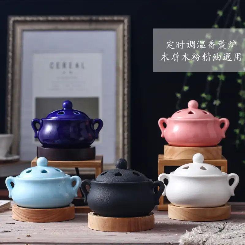 Elegant black ceramic electric incense burner with timer display and temperature control knob.