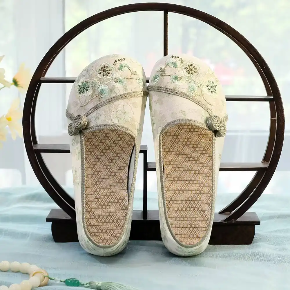 Woman wearing embroidered Chinese cloth shoes with casual outfit for lifestyle photography.