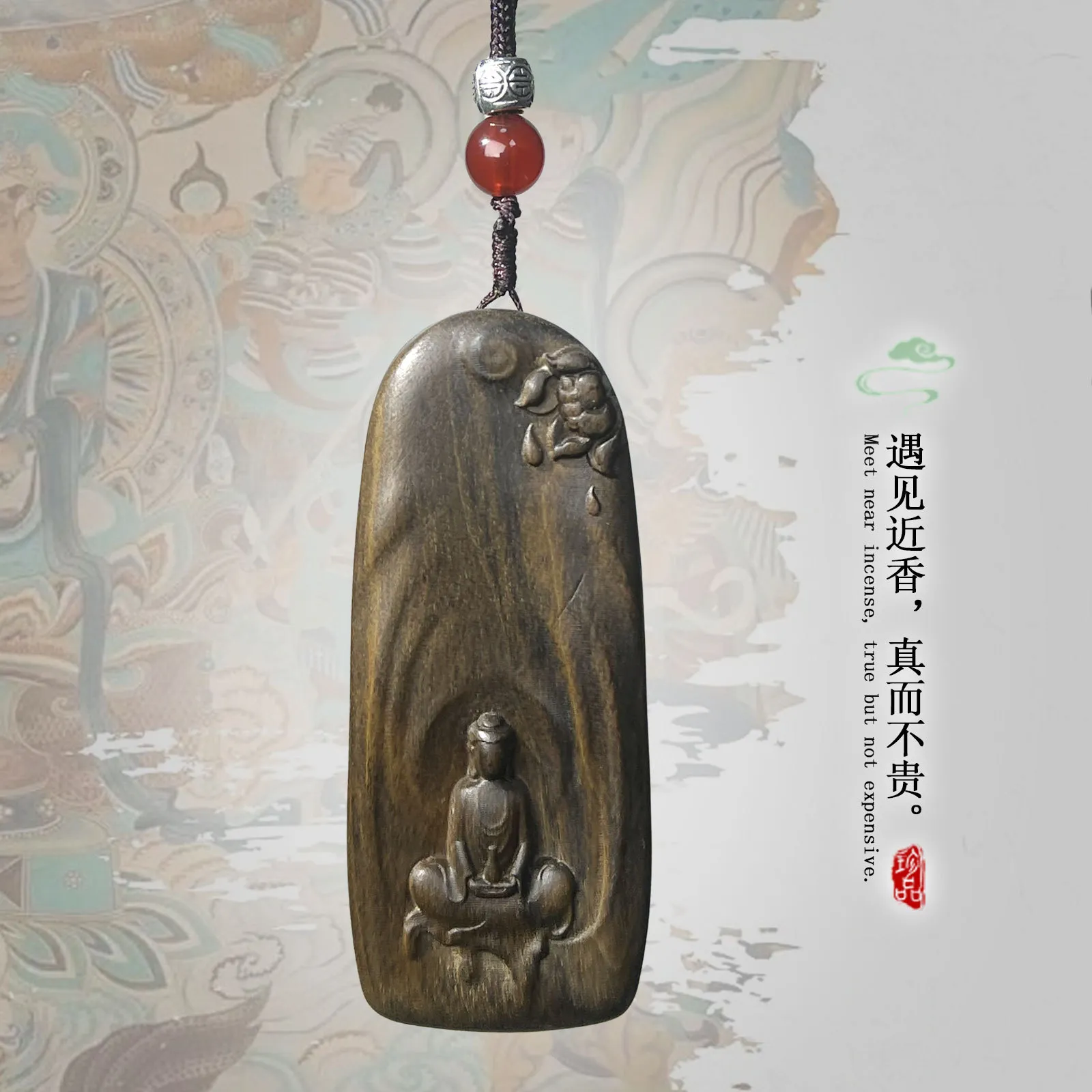 Agarwood Guanyin carving displayed with prayer beads showing spiritual meditation accessories.