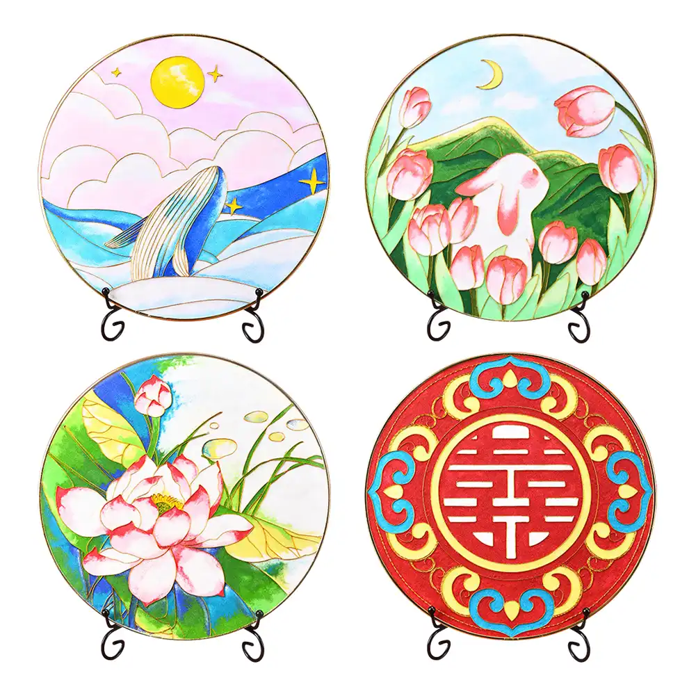 Multiple finished cloisonne paintings showing different color combinations and design variations.