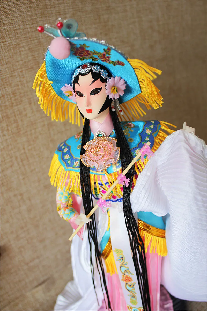 Side profile showing hand-painted facial features and costume details of Chinese doll.