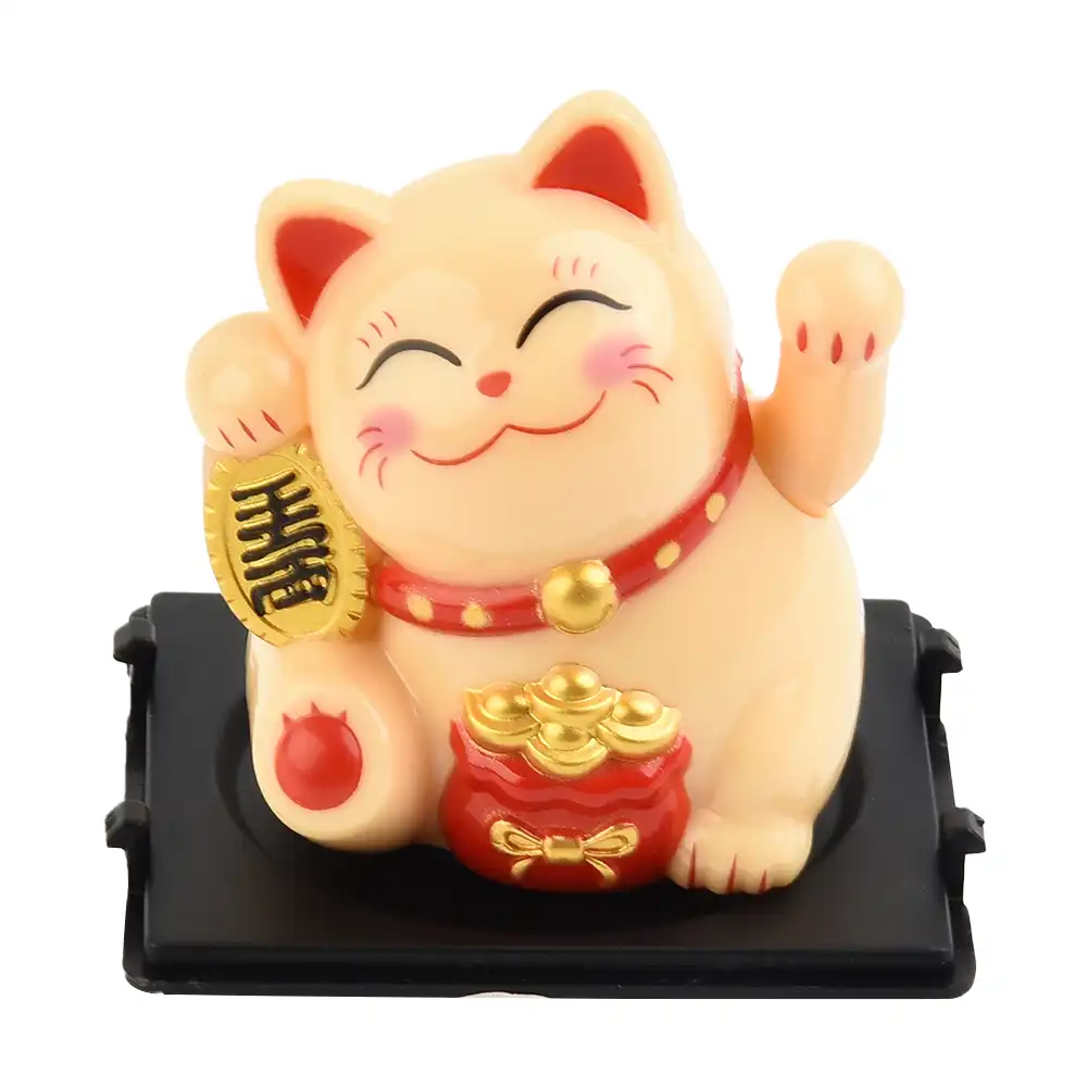 Yellow solar powered cat decoration highlighting golden ingot detail.