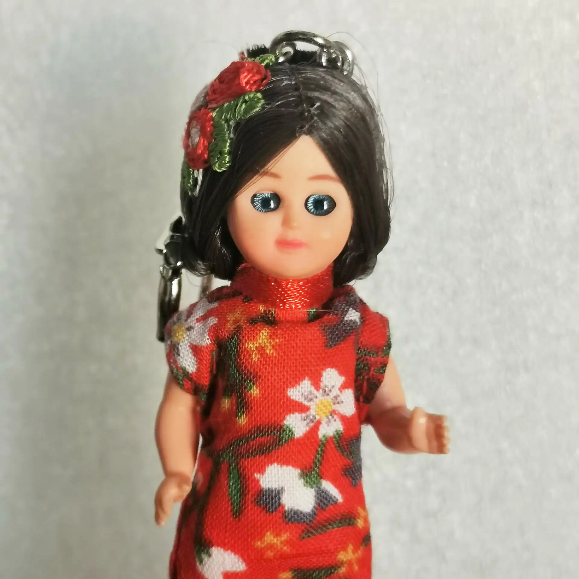 Close up of mini doll blinking wink eyes feature demonstrating charming facial expressions.