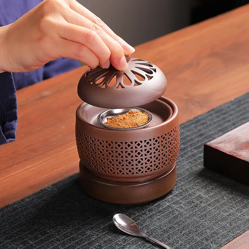 White ceramic electronic incense burner with digital timer display and temperature control knob.