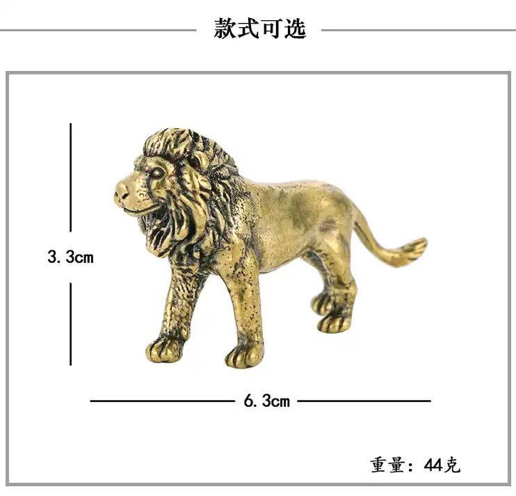 Desktop view of miniature lion statue placed next to laptop and office supplies for scale reference.