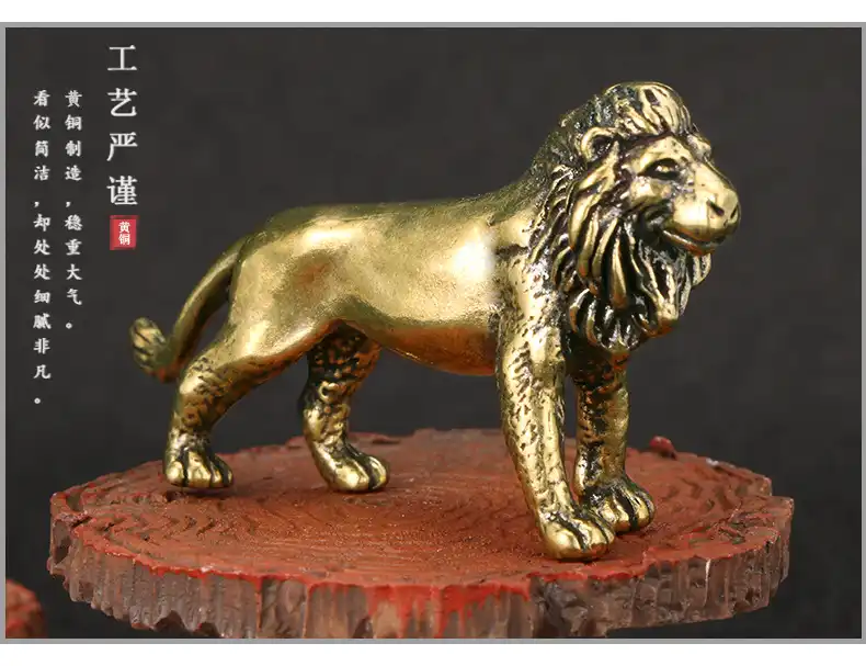 Close-up detail shot highlighting the textured mane and facial features of the brass lion ornament.