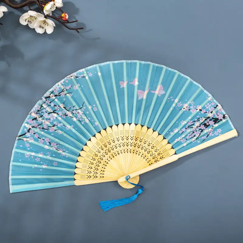 Wedding ceremony with guests holding Chinese folding fans as elegant accessories.