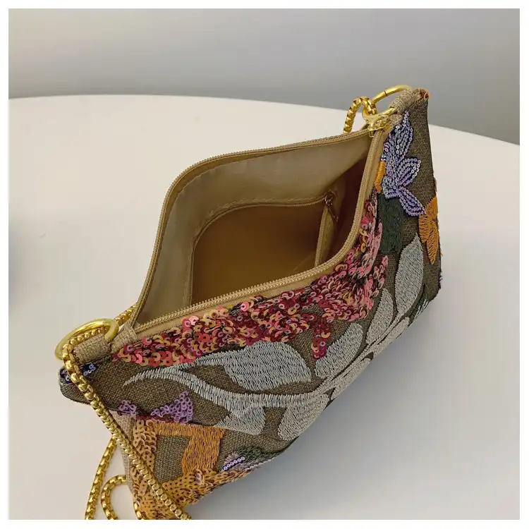 Chain shoulder strap detail of crossbody bag highlighting versatile carrying options and quality hardware.
