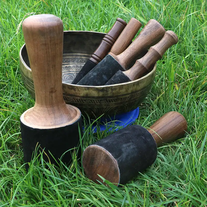 Handcrafted wooden mallet showing traditional Buddhist design and ergonomic grip handle.