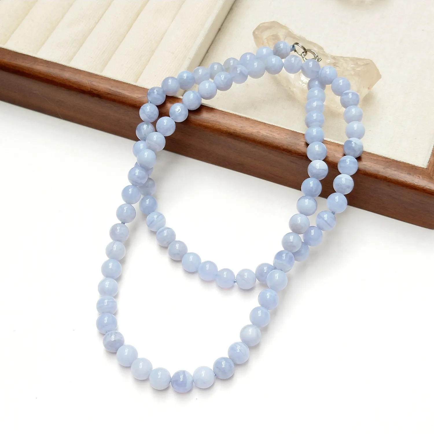 Natural 8mm Blue Lace Agate beaded necklace 70cm length showing beautiful blue banded stone pattern.