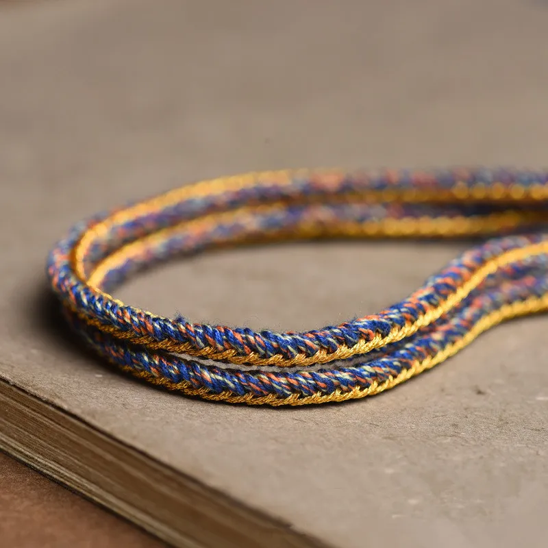 Tibetan rope necklace layered with other jewelry ethnic style fashion accessories.