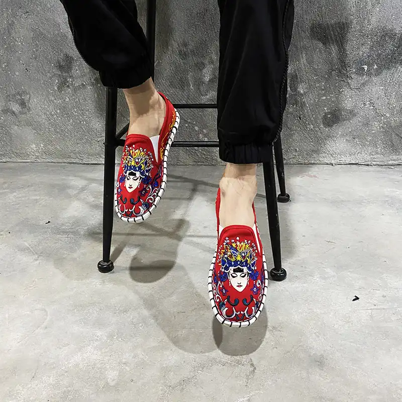 Fashion model wearing ethnic streetwear shoes with casual outfit in urban setting.