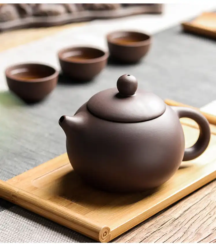 Overhead view of large capacity Xishi teapot interior highlighting purple clay texture and brewing space.
