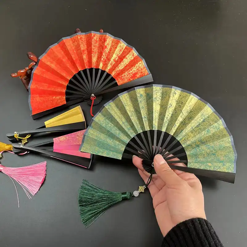 Dance performance using colorful paper fans as props highlighting cultural and artistic applications.