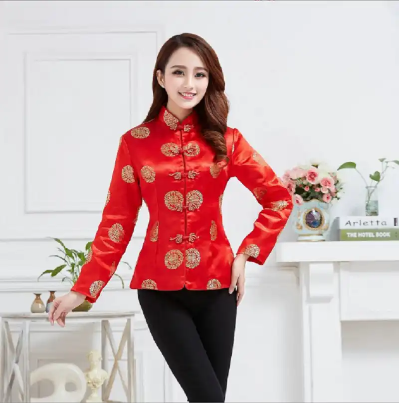 Model wearing elegant red satin tang suit jacket with traditional mandarin collar and long sleeves.