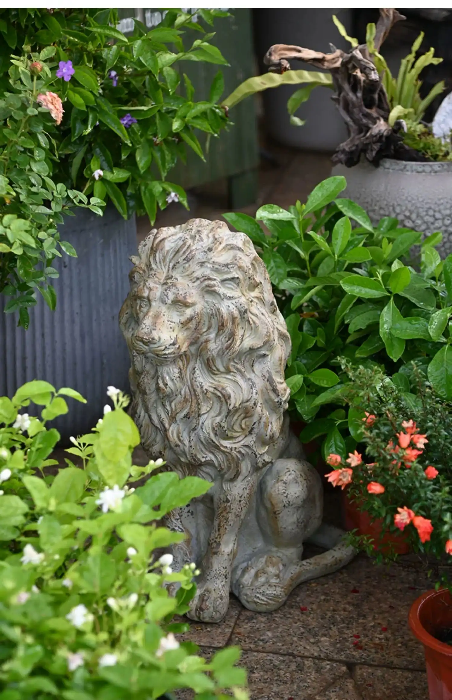 Pair of resin lion statues flanking garden entrance demonstrating foyer decoration placement.