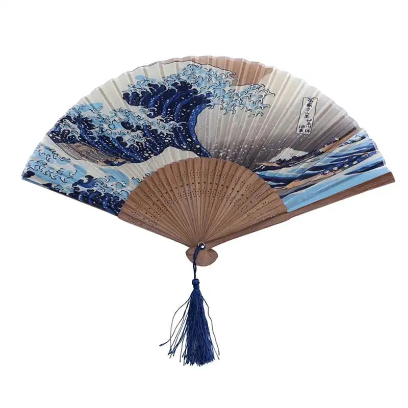 Traditional Japanese fan displayed on wooden surface showcasing elegant wave design and premium materials.