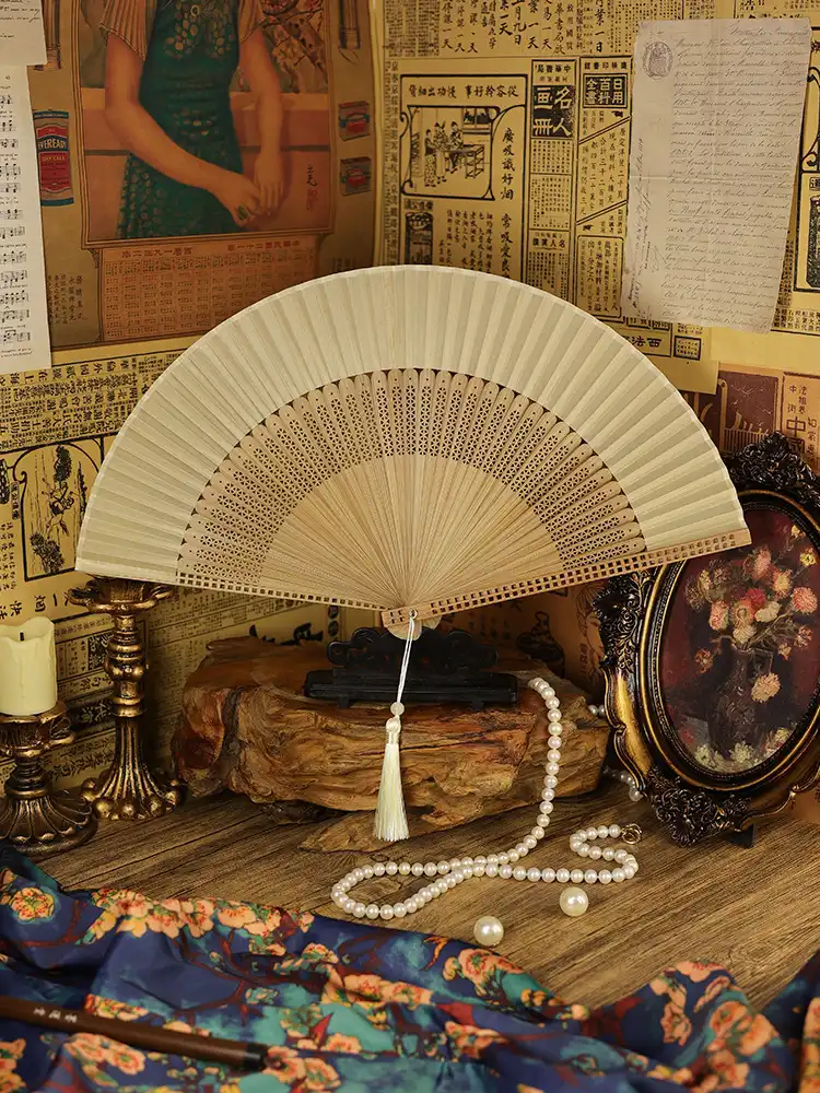 Red colored bamboo folding fan highlighting vibrant summer shade and quality construction.