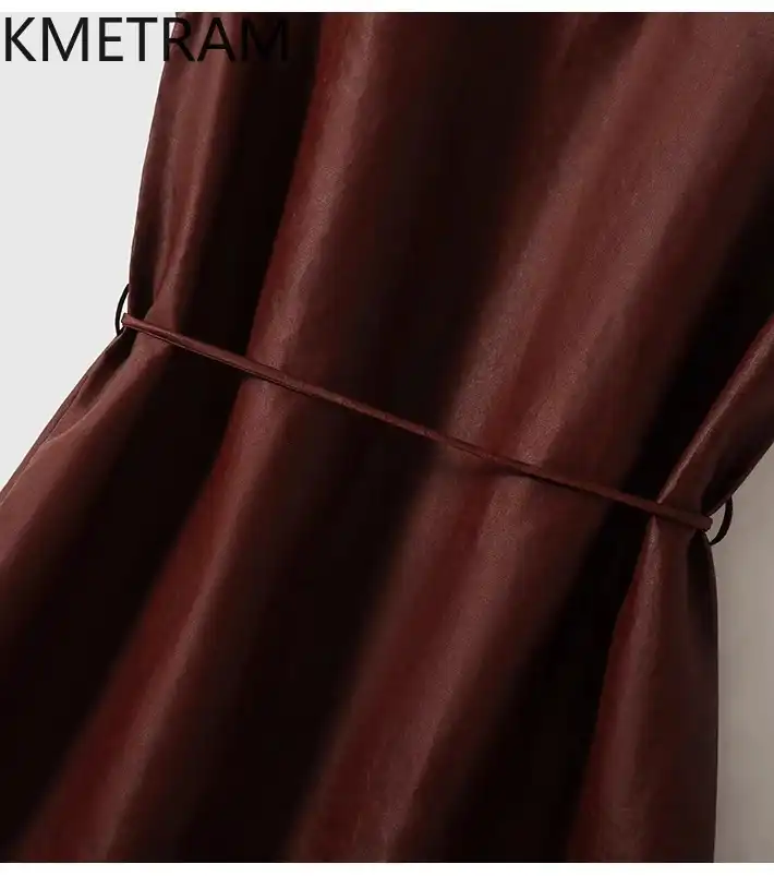 Professional woman in silk dress showcasing elegant office wear and versatile summer styling.