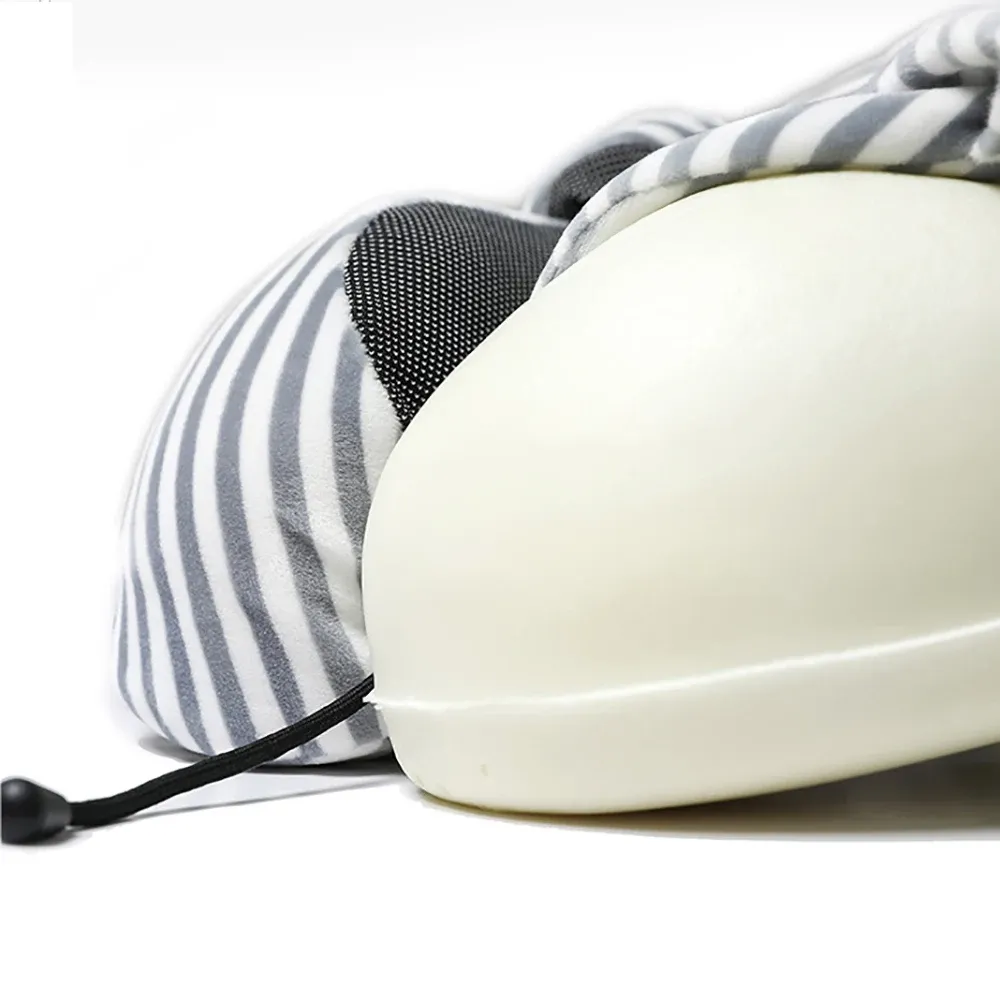 Person using U-shaped travel pillow on airplane seat demonstrating proper neck support position.