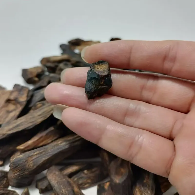 ​​Close-up of double super grade Cambodia oud incense cones displaying natural wood texture and craftsmanship.