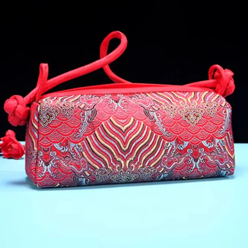Brown silk embroidered shoulder bag displaying rich color tones and traditional craftsmanship.