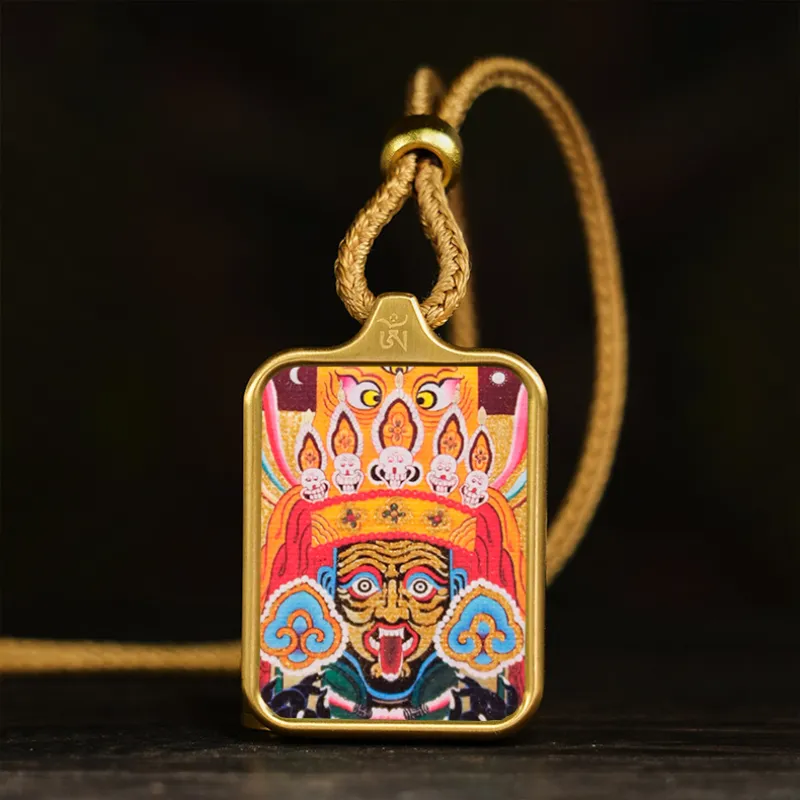 Close-up detail of God of Wealth and Green Tara Buddhist designs on geometric pendant.