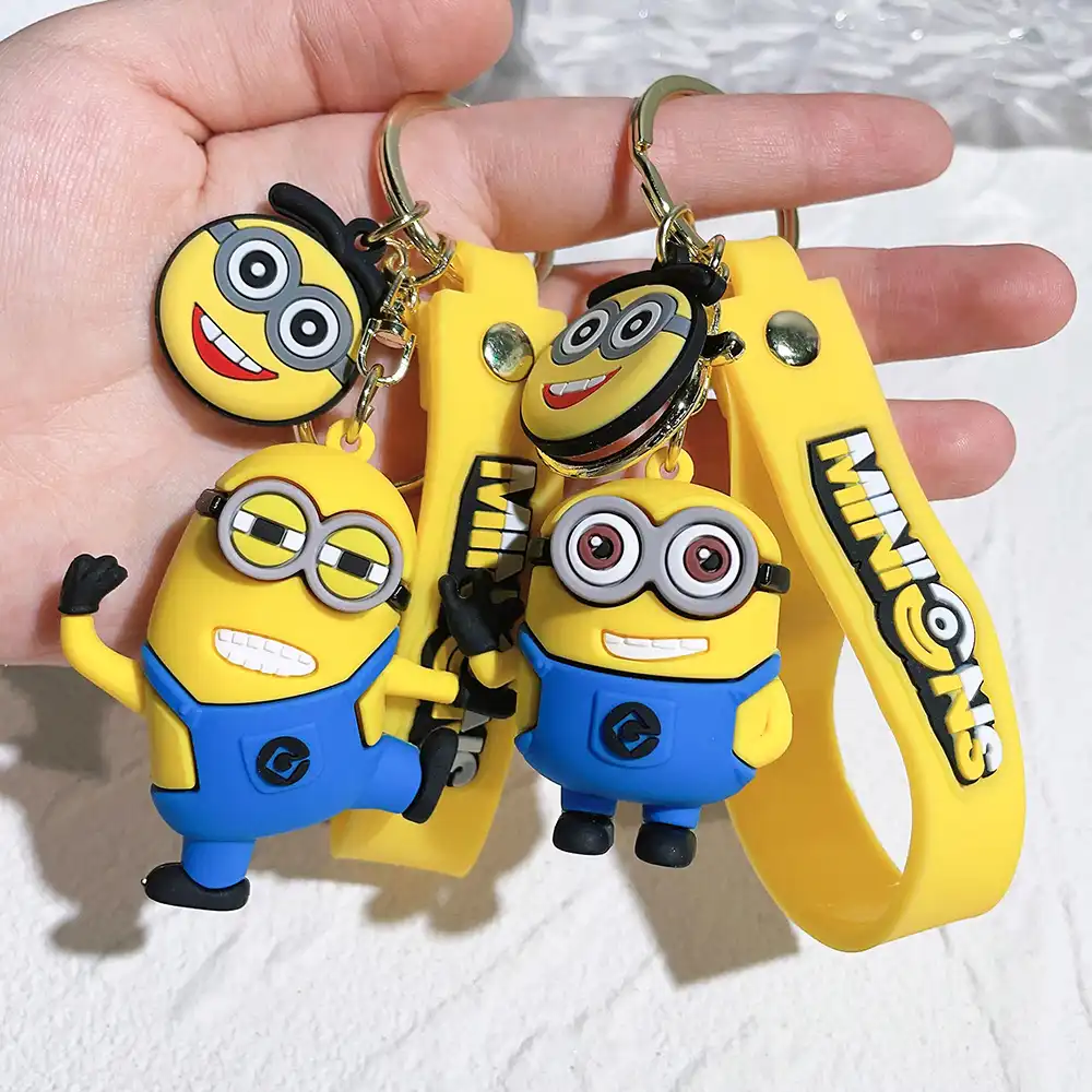 Cute yellow Minions keychain with big googly eyes attached to lobster clasp on white background.