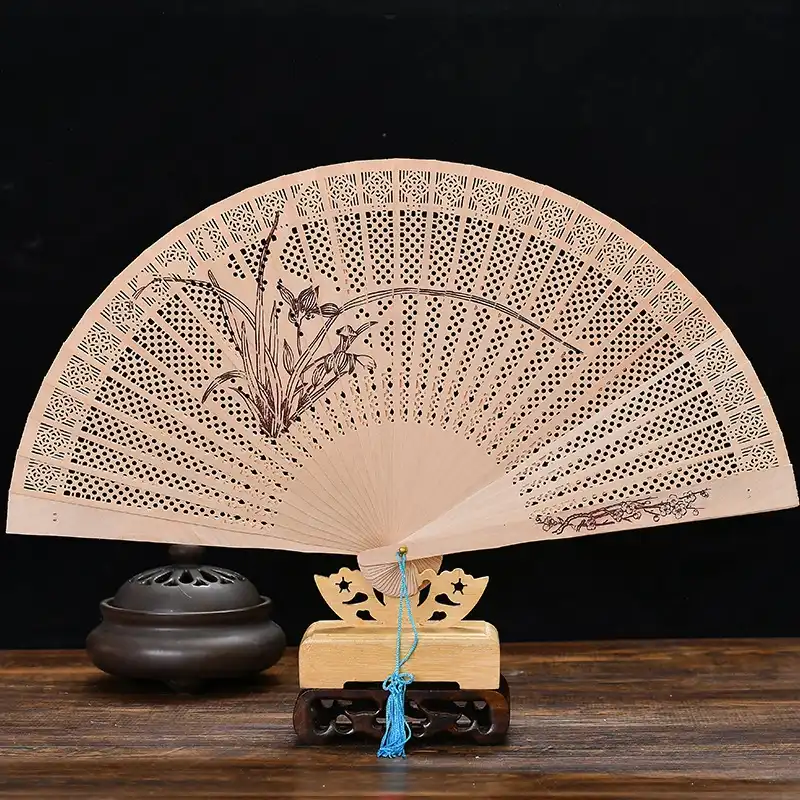 Traditional Chinese folding fan opened showing 34cm diameter and intricate carved decorations.