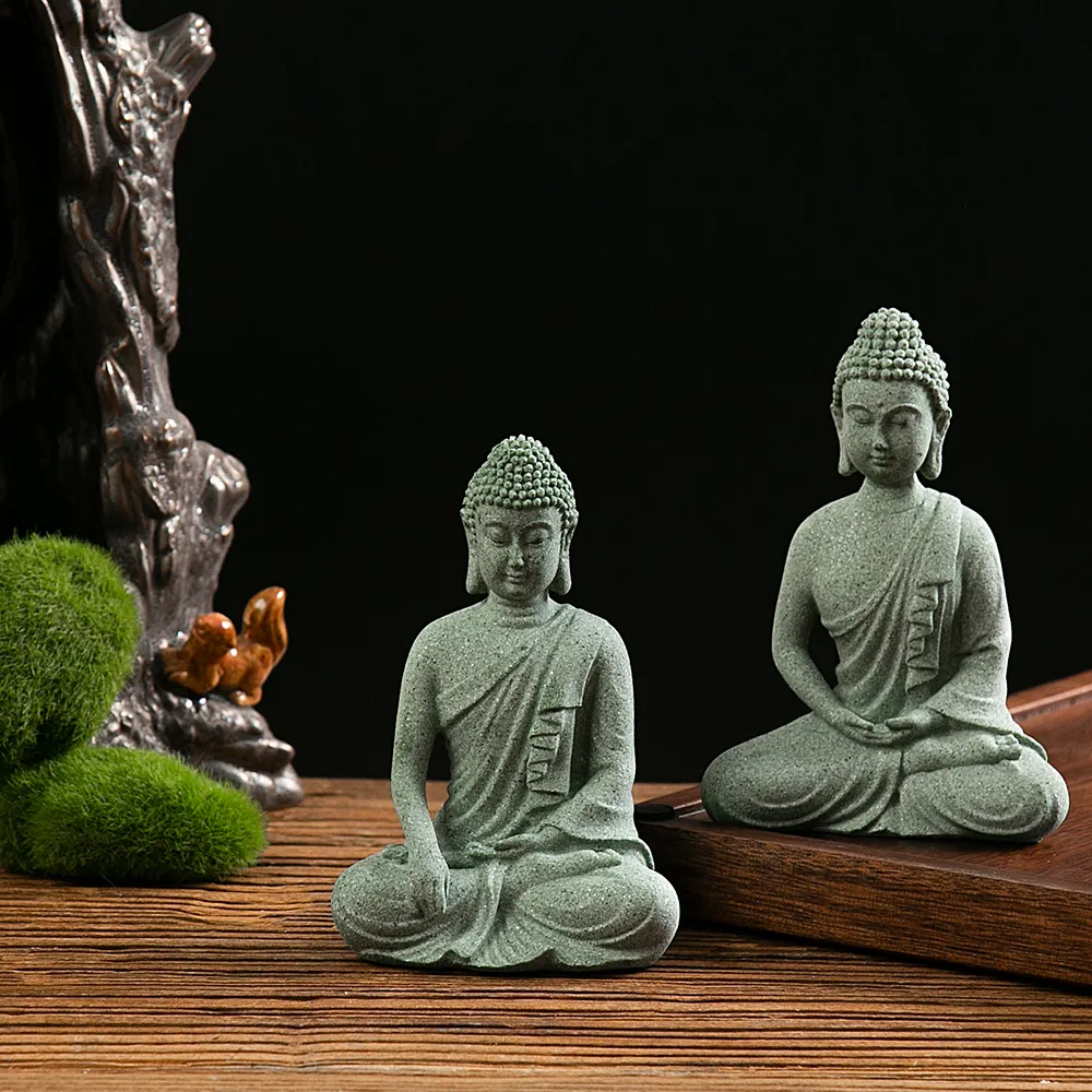 Small Buddha statue decoration placed in fish tank aquarium creating peaceful underwater zen.