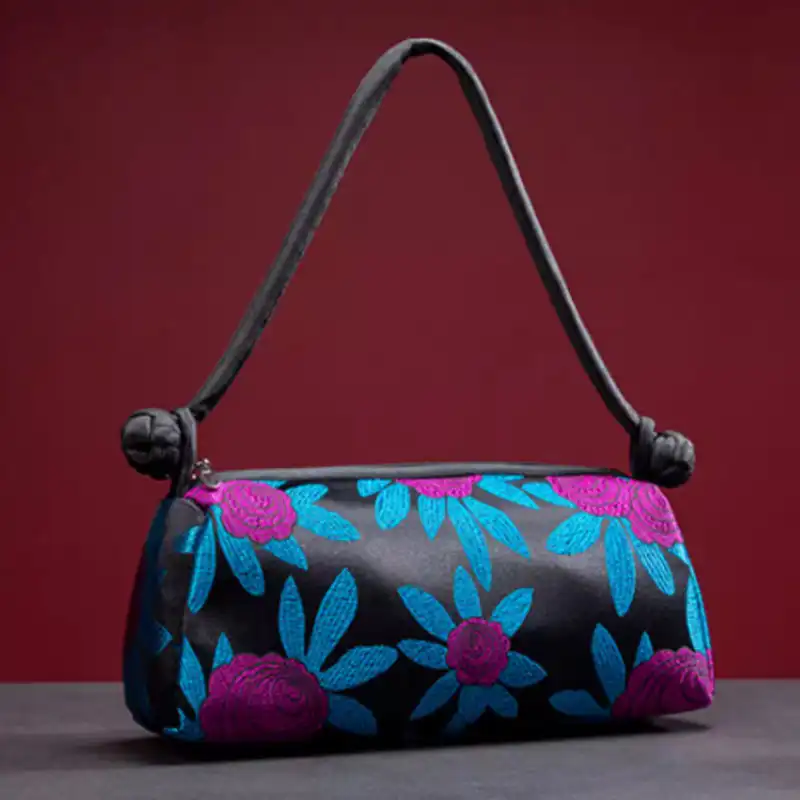 Shoulder strap of embroidered silk bag demonstrating versatile carrying options for women.