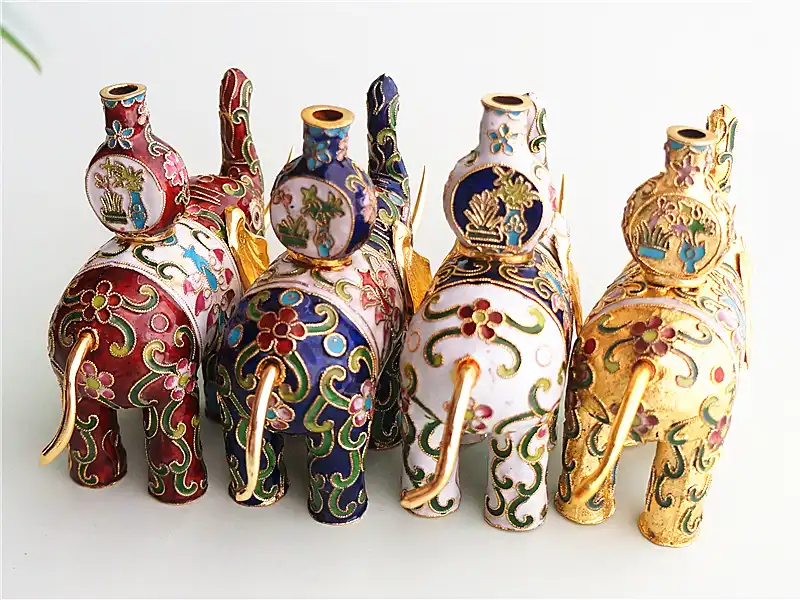 Side profile of vintage enamel elephant figurine revealing traditional Chinese artistry.