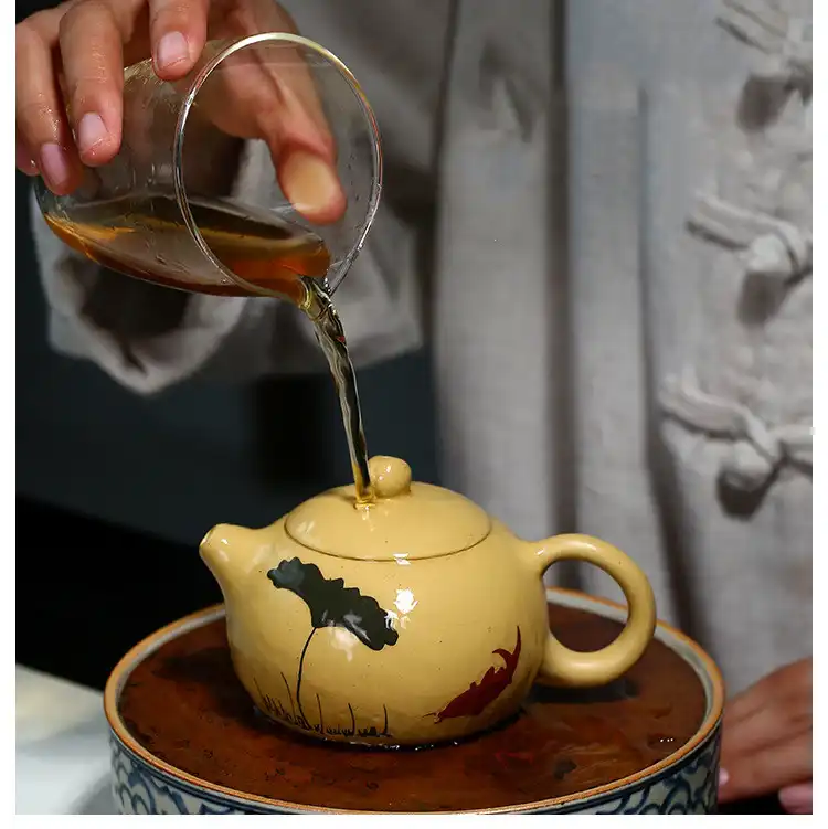 Folk artist handcrafting authentic Xi Shi purple clay teapot using centuries-old techniques.