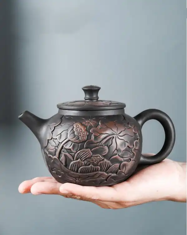 Complete traditional tea set arrangement with lotus carved black mud purple clay teapot centerpiece.