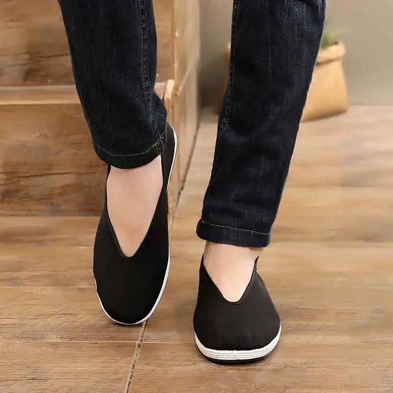 Kung fu shoes modeled with traditional martial arts uniform showing complete training outfit.