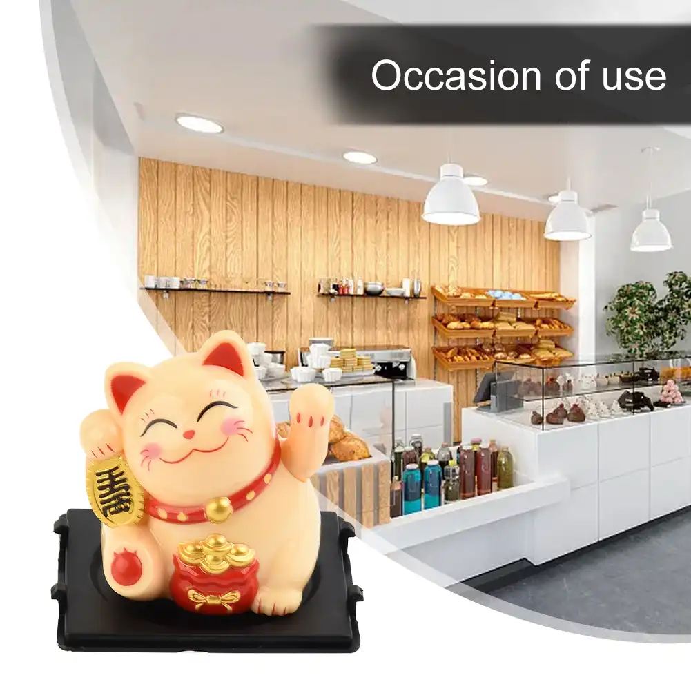 Quality control inspection of solar powered lucky cat dashboard decoration.
