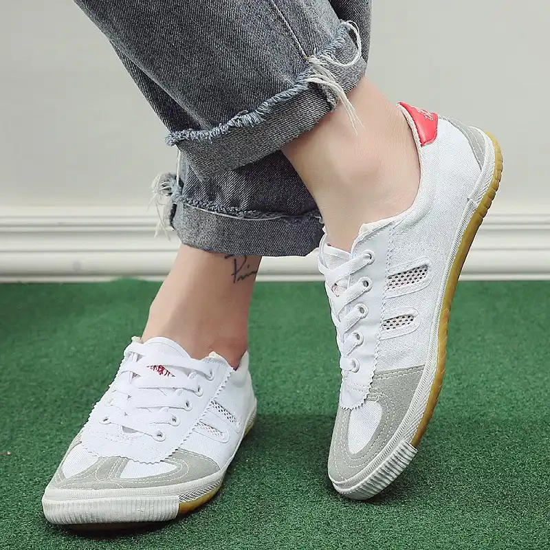 Unisex canvas kung fu shoes worn during tai chi and wushu training demonstration session.