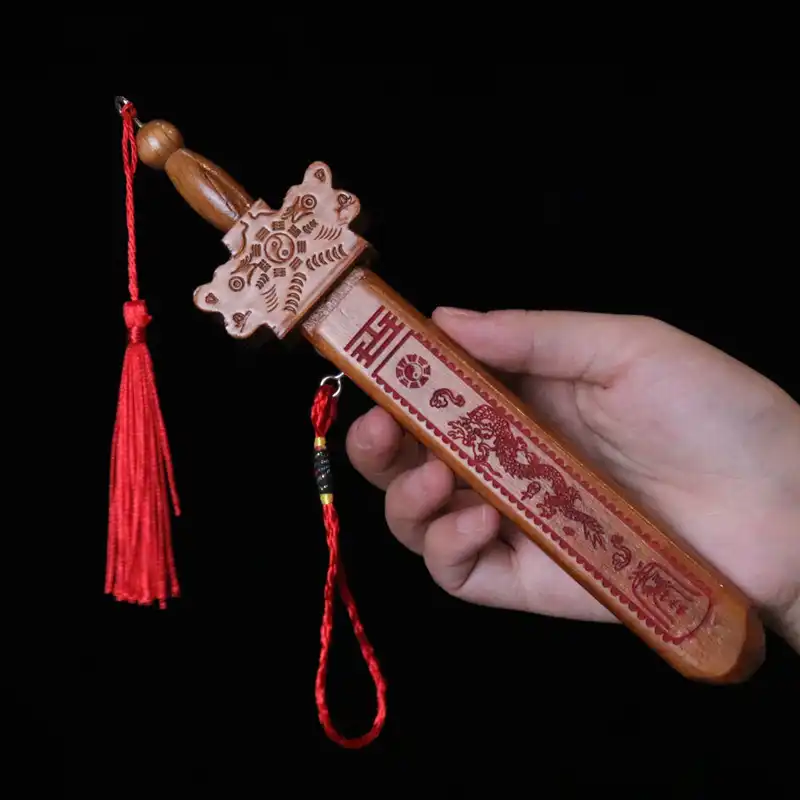 Peach wood sword toy displayed with traditional Chinese cultural elements and decorative background.