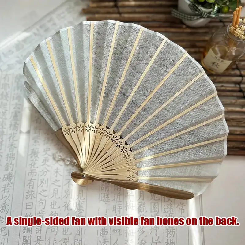 Shell shaped fan used as wedding accessory demonstrating appropriate formal occasion styling.