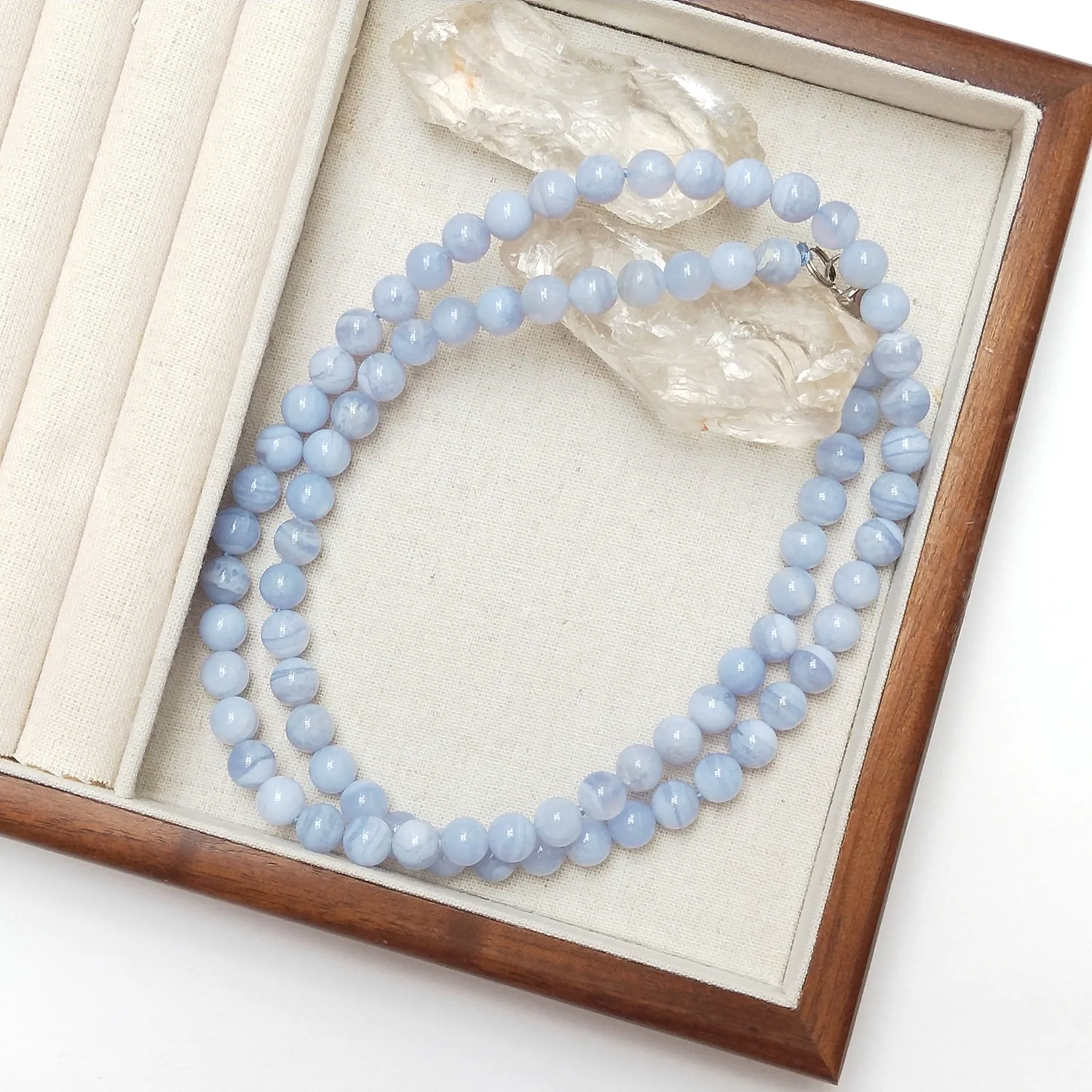 Woman wearing Blue Lace Agate necklace demonstrating elegant styling and natural stone beauty.